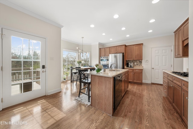 kitchen with light countertops, decorative backsplash, wood finished floors, brown cabinetry, and stainless steel appliances