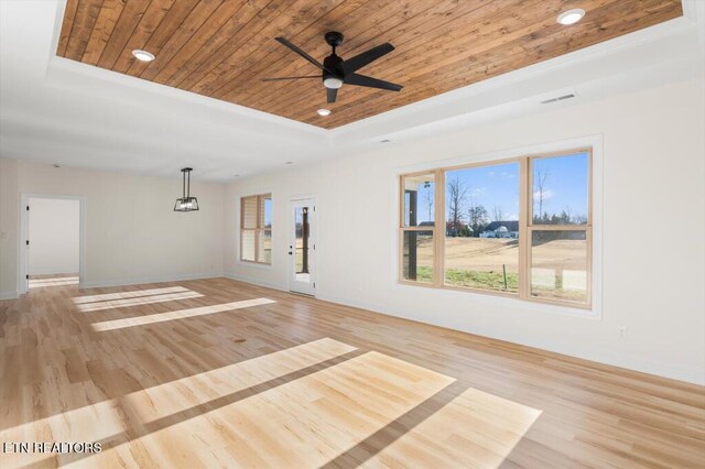 spare room featuring ceiling fan, light hardwood / wood-style floors, wooden ceiling, and a tray ceiling