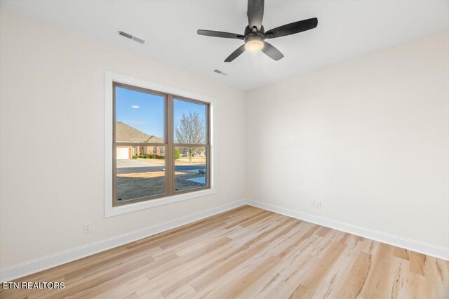 spare room featuring ceiling fan and light hardwood / wood-style flooring