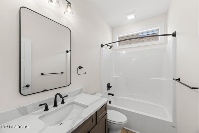 full bathroom featuring vanity, toilet, and tub / shower combination