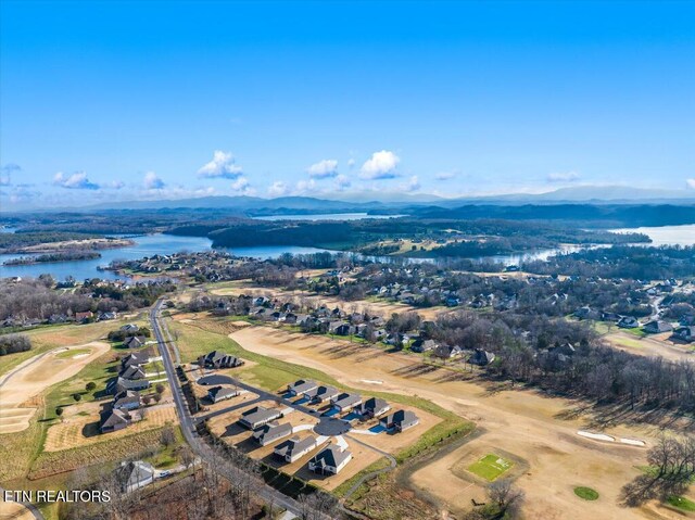 birds eye view of property featuring a water and mountain view