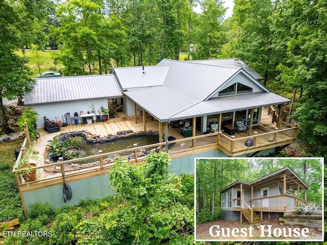 rear view of house featuring a wooden deck