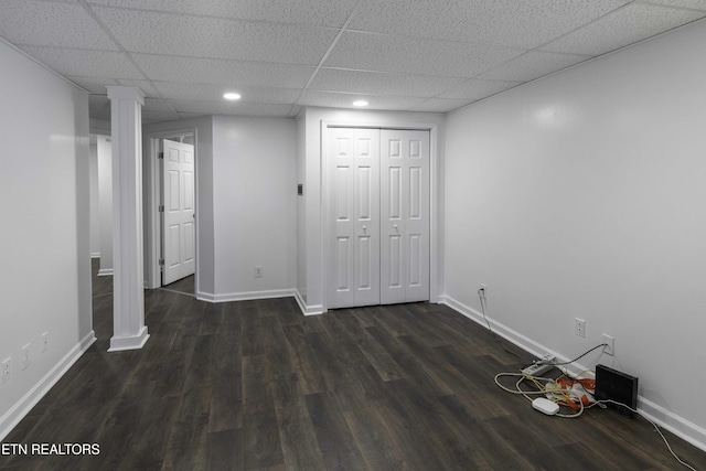 interior space featuring a drop ceiling and dark wood-type flooring