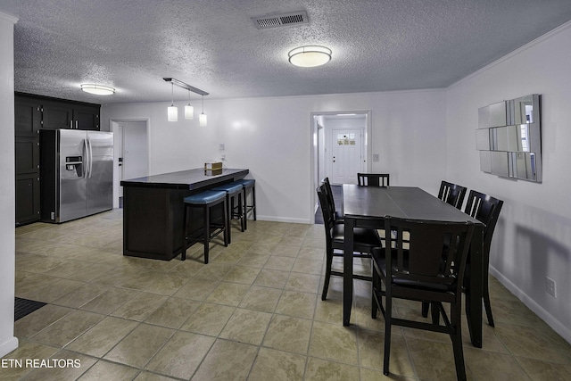 dining space featuring a textured ceiling