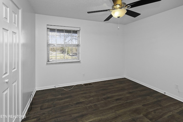 spare room featuring ceiling fan and dark hardwood / wood-style flooring