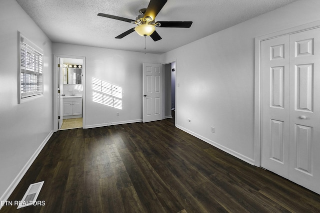 interior space with a textured ceiling, ceiling fan, dark hardwood / wood-style flooring, and sink