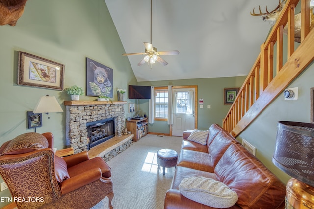 living room with ceiling fan, carpet floors, a fireplace, and high vaulted ceiling