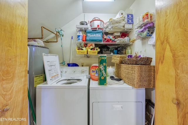 clothes washing area featuring water heater and washing machine and clothes dryer