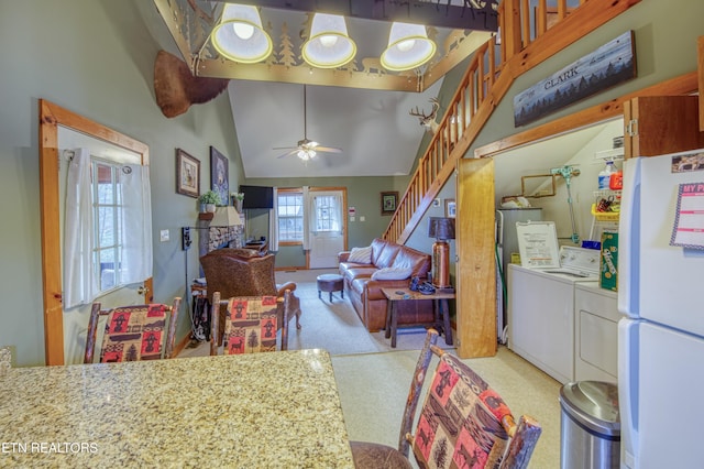 kitchen featuring lofted ceiling, light carpet, white refrigerator, ceiling fan, and independent washer and dryer