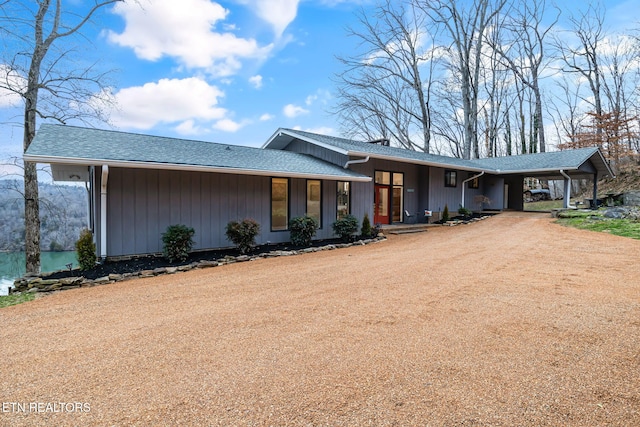 single story home featuring a carport