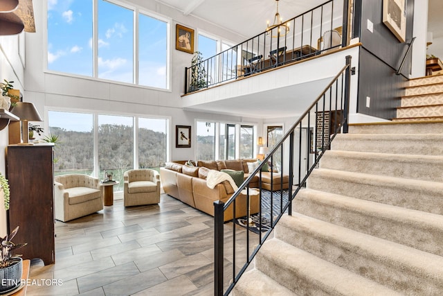 living room featuring a chandelier and a high ceiling