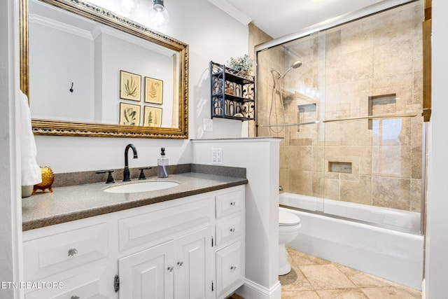 full bathroom featuring toilet, ornamental molding, vanity, and shower / bath combination with glass door