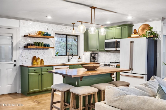 kitchen featuring decorative light fixtures, wooden counters, crown molding, and white appliances