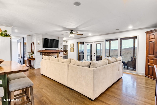 living room featuring ceiling fan, french doors, and hardwood / wood-style floors