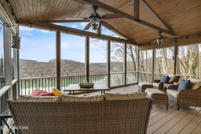 sunroom featuring a water view, ceiling fan, vaulted ceiling, and wooden ceiling