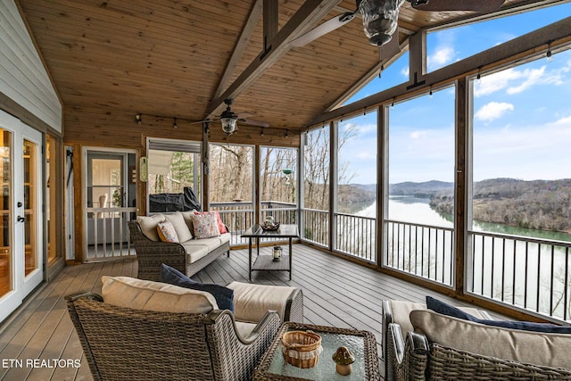 sunroom with wood ceiling, plenty of natural light, a water view, and vaulted ceiling with beams