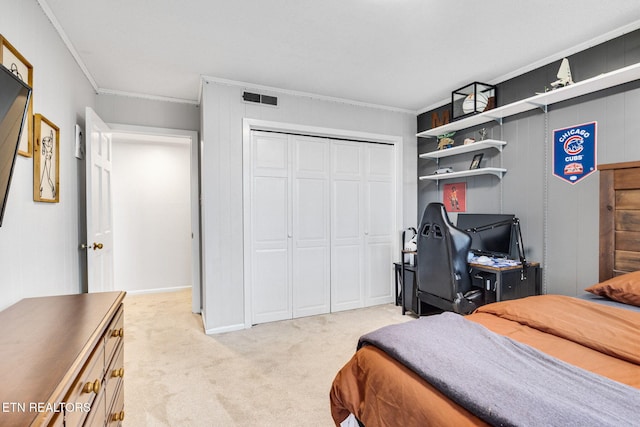 bedroom featuring light carpet, a closet, and ornamental molding