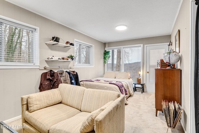 bedroom featuring light colored carpet and ornamental molding