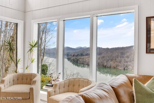 sunroom / solarium with a water and mountain view