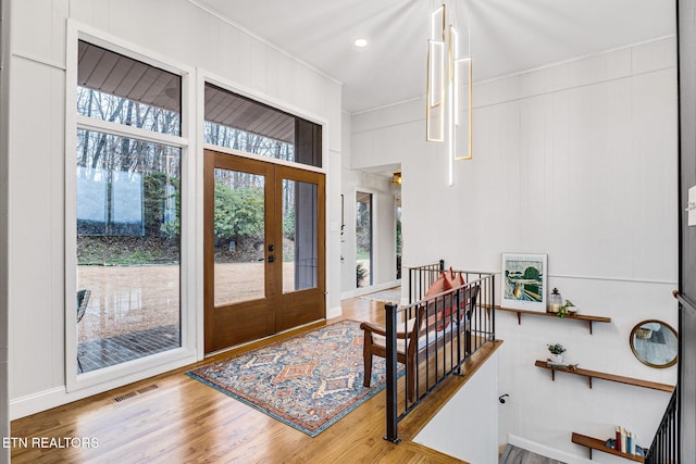 foyer entrance with french doors and hardwood / wood-style floors