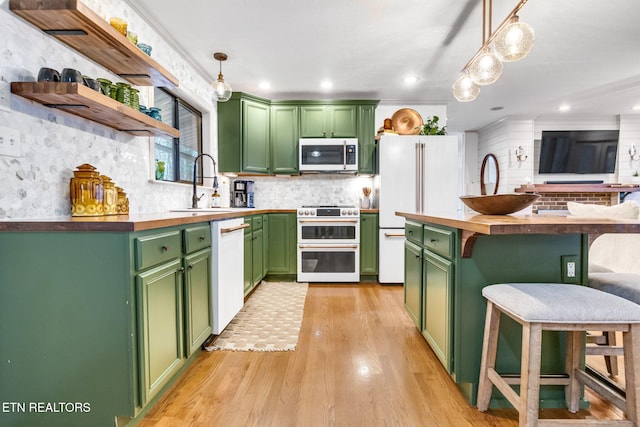 kitchen featuring wood counters, white appliances, and green cabinets