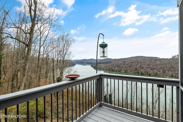 wooden deck featuring a water view