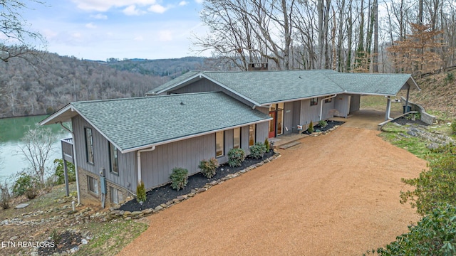 view of front of home with a water view and a carport