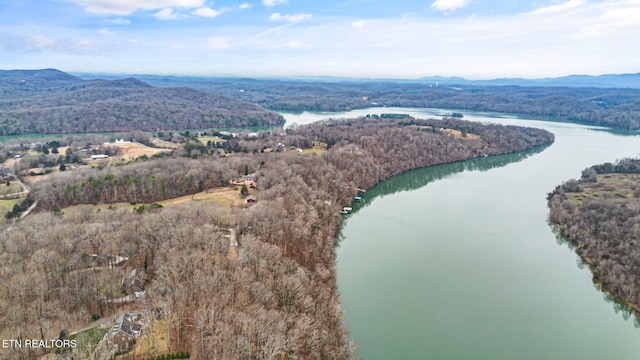 drone / aerial view featuring a water and mountain view