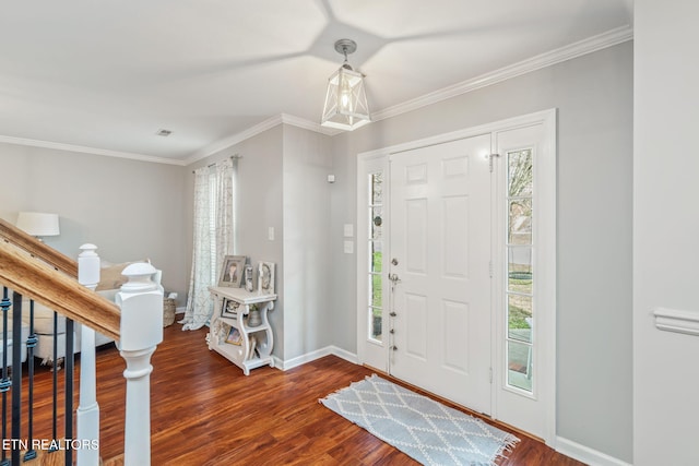 entryway with wood-type flooring and crown molding