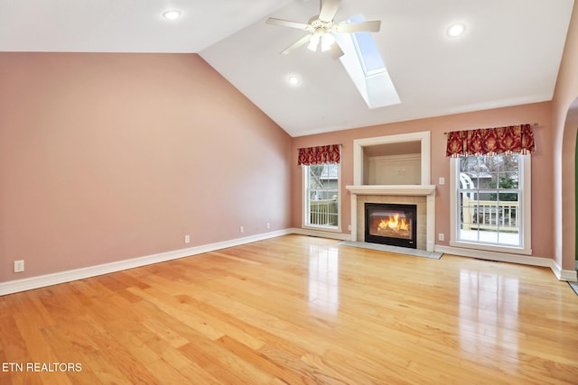 unfurnished living room with a fireplace, light wood-type flooring, and a wealth of natural light