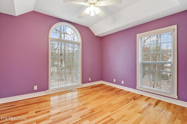 unfurnished room with lofted ceiling, hardwood / wood-style floors, and ceiling fan