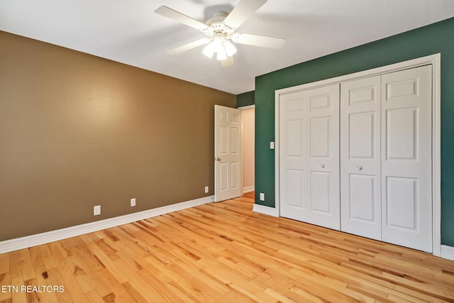 unfurnished bedroom featuring a closet, ceiling fan, and light wood-type flooring