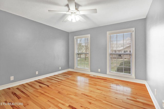 spare room featuring ceiling fan and light hardwood / wood-style flooring