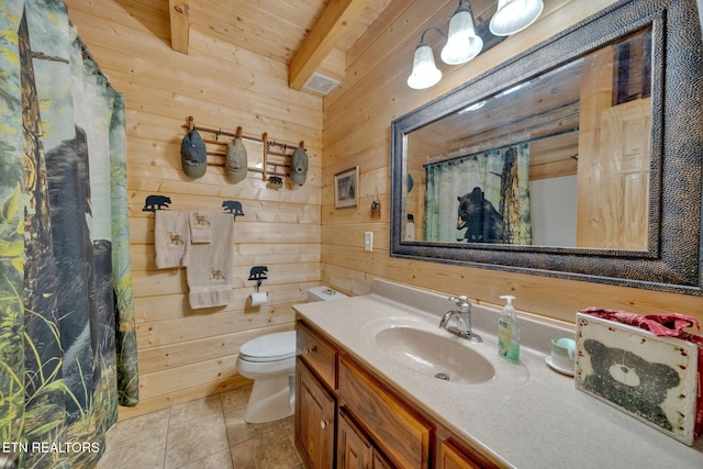 bathroom with vanity, wooden walls, tile patterned flooring, beam ceiling, and wood ceiling