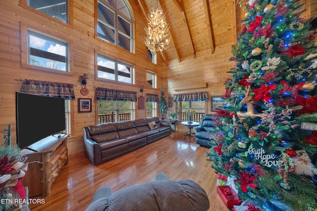 living room featuring wood walls, beam ceiling, wood ceiling, and high vaulted ceiling