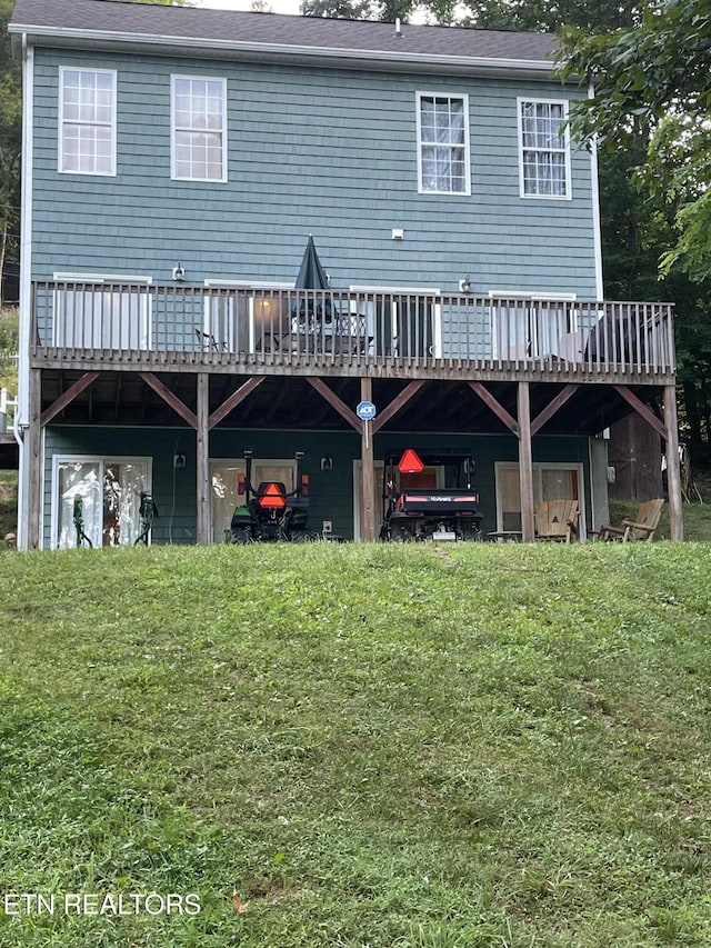 rear view of house with a yard and a deck