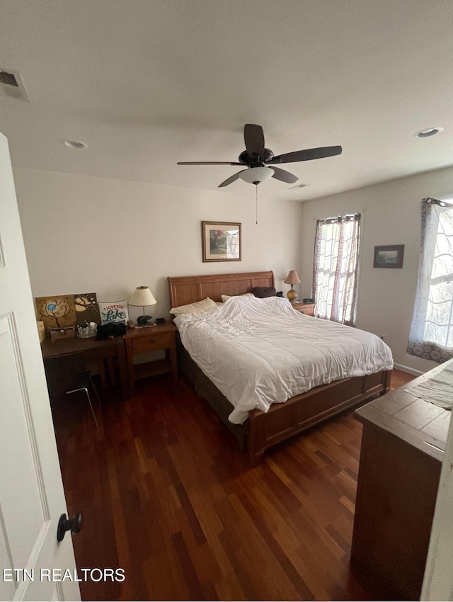 bedroom with ceiling fan and dark hardwood / wood-style floors