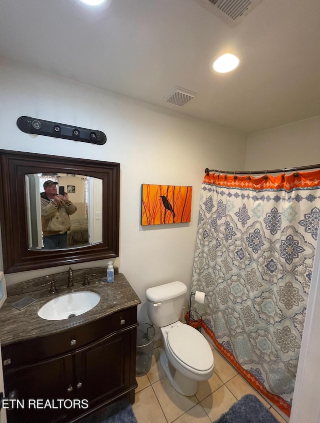 bathroom featuring tile patterned flooring, vanity, and toilet