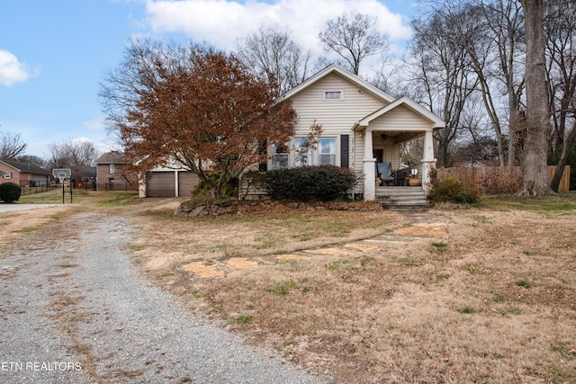 view of front of house with an outbuilding, a porch, and a garage