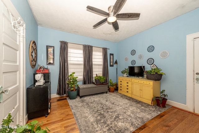 sitting room featuring light hardwood / wood-style flooring and ceiling fan