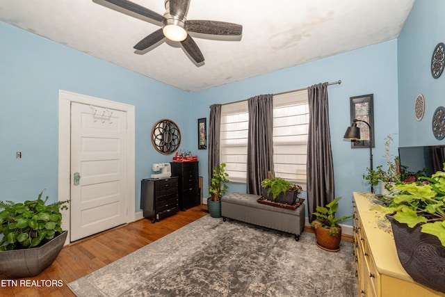 interior space with dark hardwood / wood-style flooring and ceiling fan