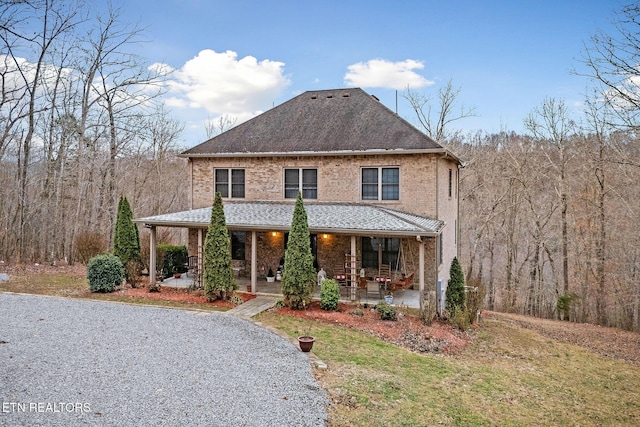 view of property with a front lawn and a patio