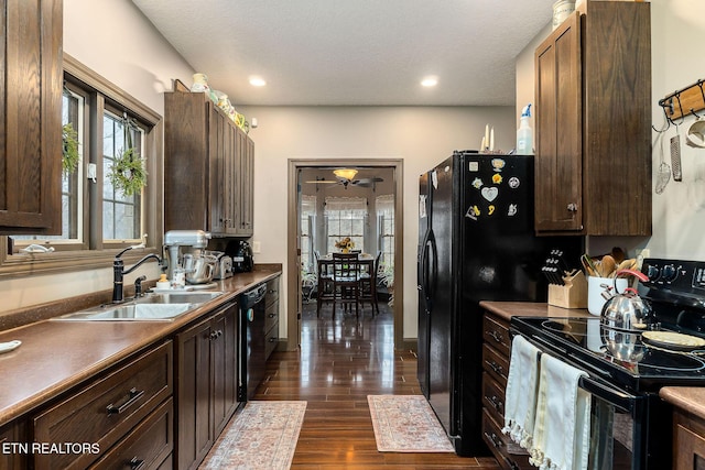 kitchen featuring sink, ceiling fan, dark wood-type flooring, and black appliances