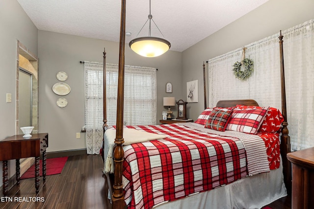 bedroom featuring a textured ceiling and dark wood-type flooring