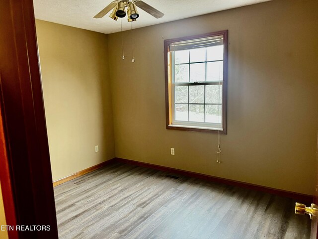 empty room featuring ceiling fan, a textured ceiling, and light hardwood / wood-style flooring