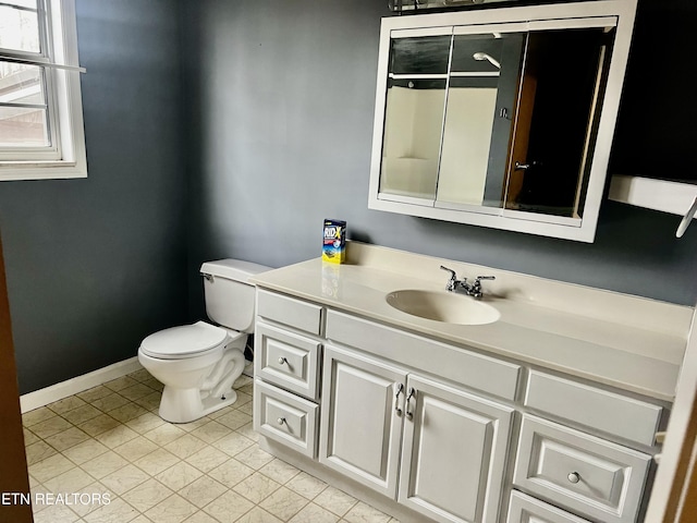 bathroom with tile patterned flooring, vanity, and toilet