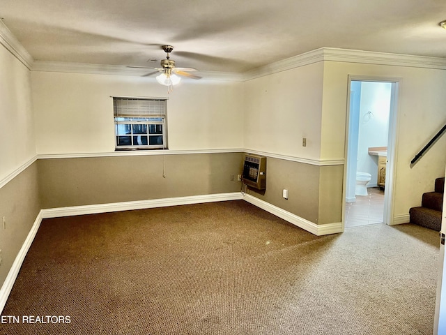 spare room featuring heating unit, ceiling fan, and crown molding