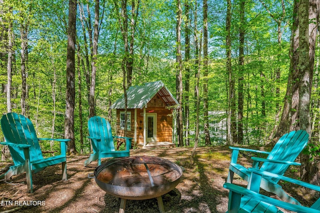 view of patio / terrace with an outbuilding and an outdoor fire pit