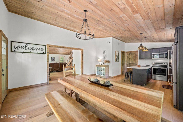 dining area featuring a chandelier, light hardwood / wood-style floors, and wooden ceiling