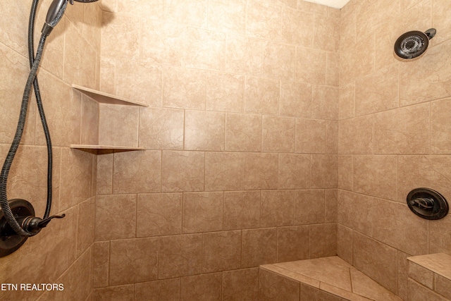 bathroom with tiled shower